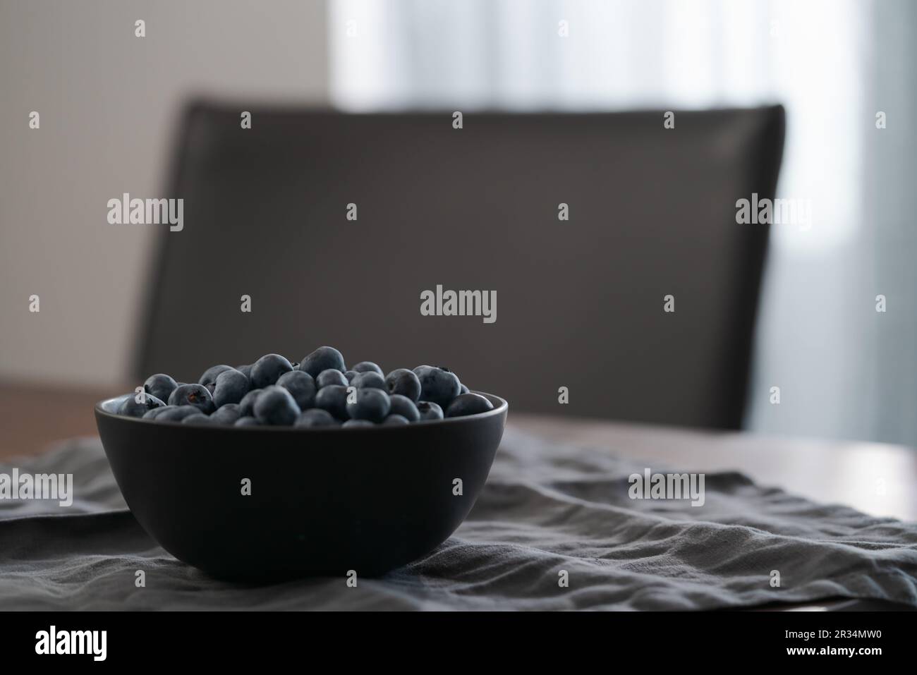 Große Schüssel mit Heidelbeeren auf dem Tisch, flacher Fokus Stockfoto