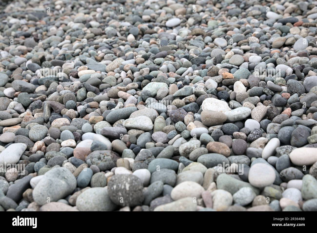 Viele verschiedene Kieselsteine wie Hintergrund, Nahaufnahme Stockfoto