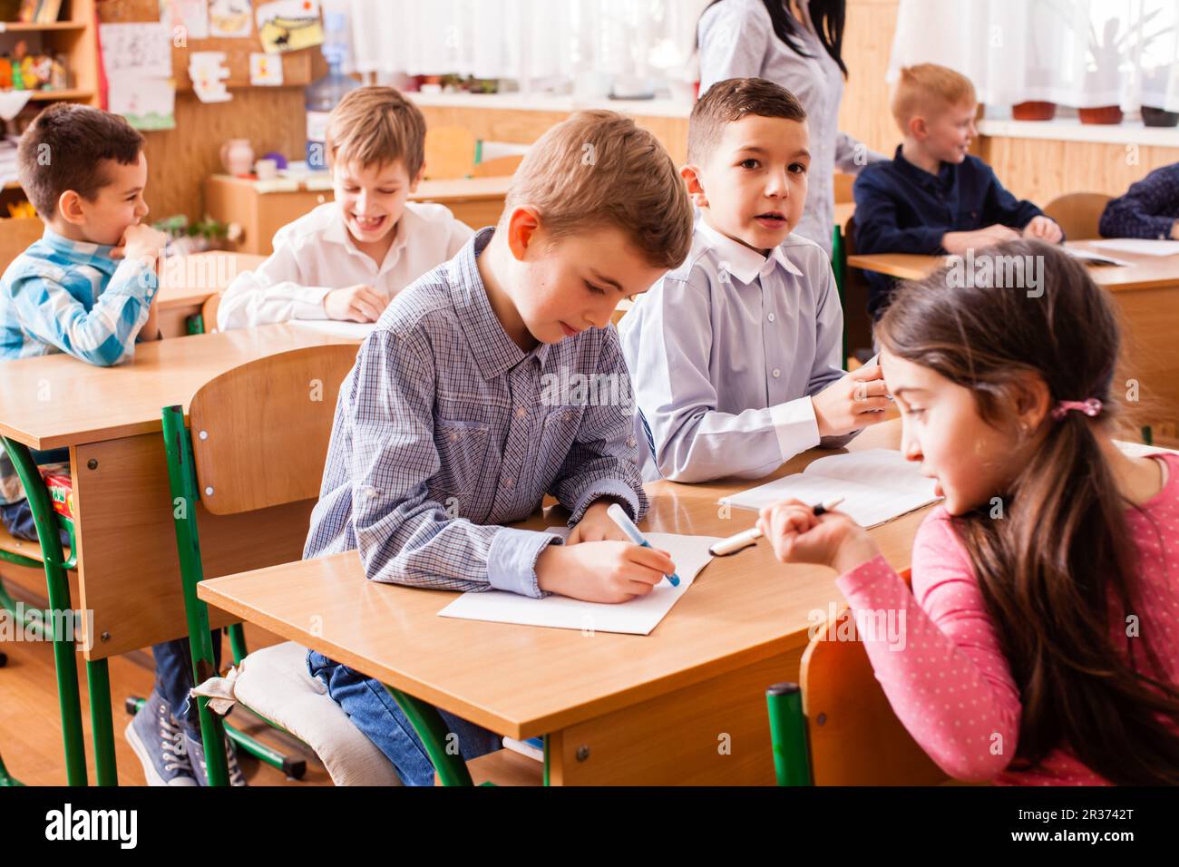 Schulmädchen erklären ihr Klassenkamerad Stockfoto