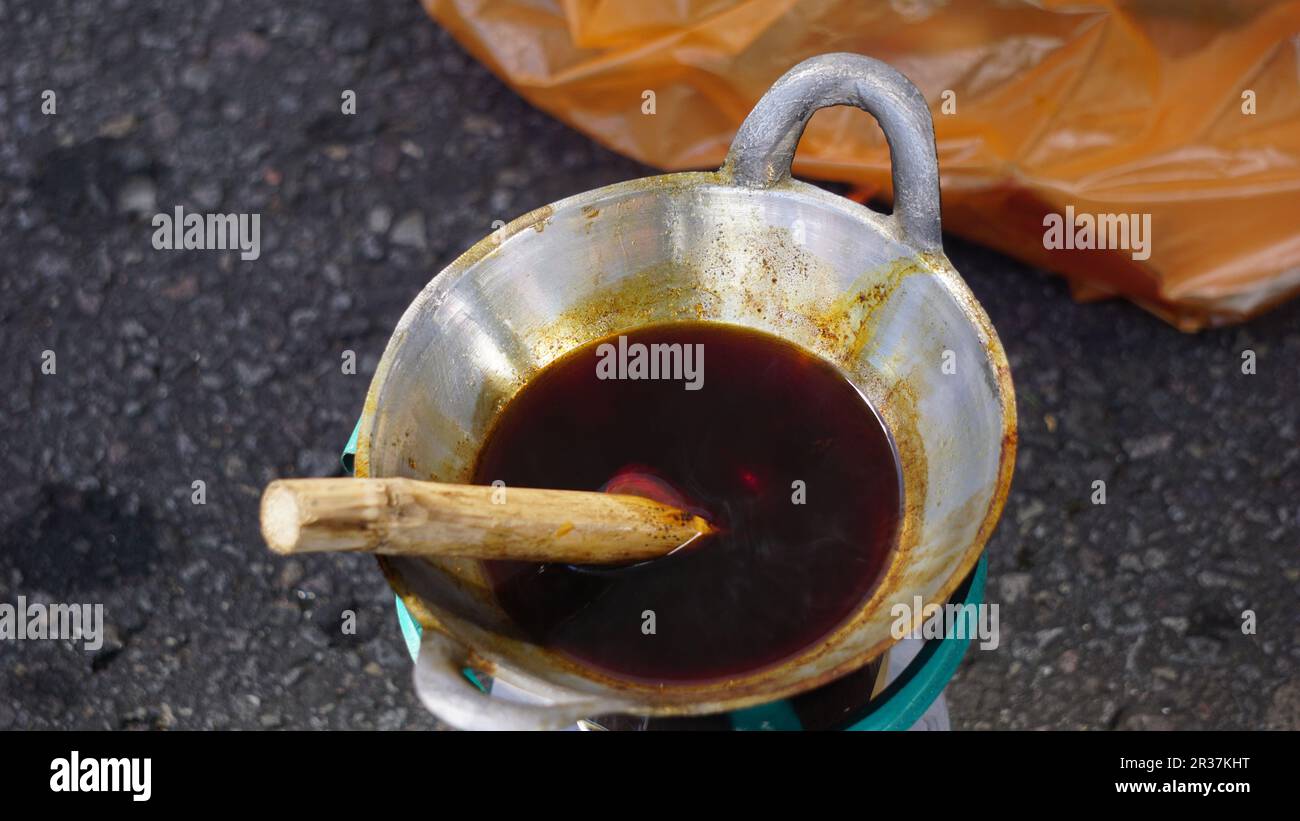 Das Wachs (Indonesien nennt es Malam) schmilzt in der Pfanne. Dieses Wachs wird bei der Herstellung von Batiktuch verwendet Stockfoto