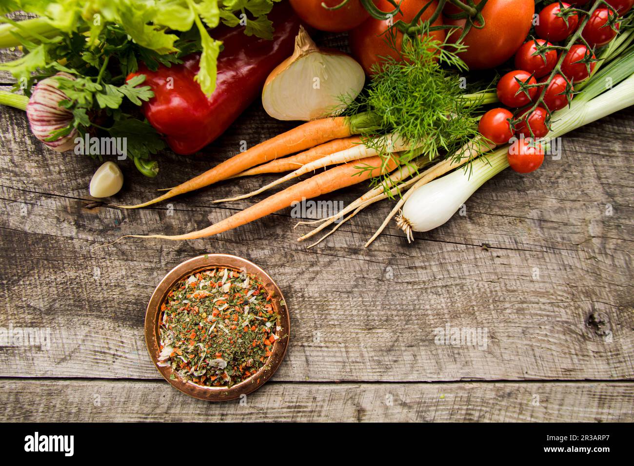 Teller mit Gewürzmischung und frischem Gemüse, Zutaten zum Würzen Stockfoto