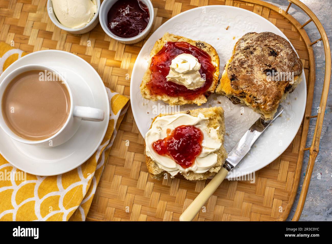 Tee und Scones mit Clotted Cream und Erdbeermarmelade Stockfoto