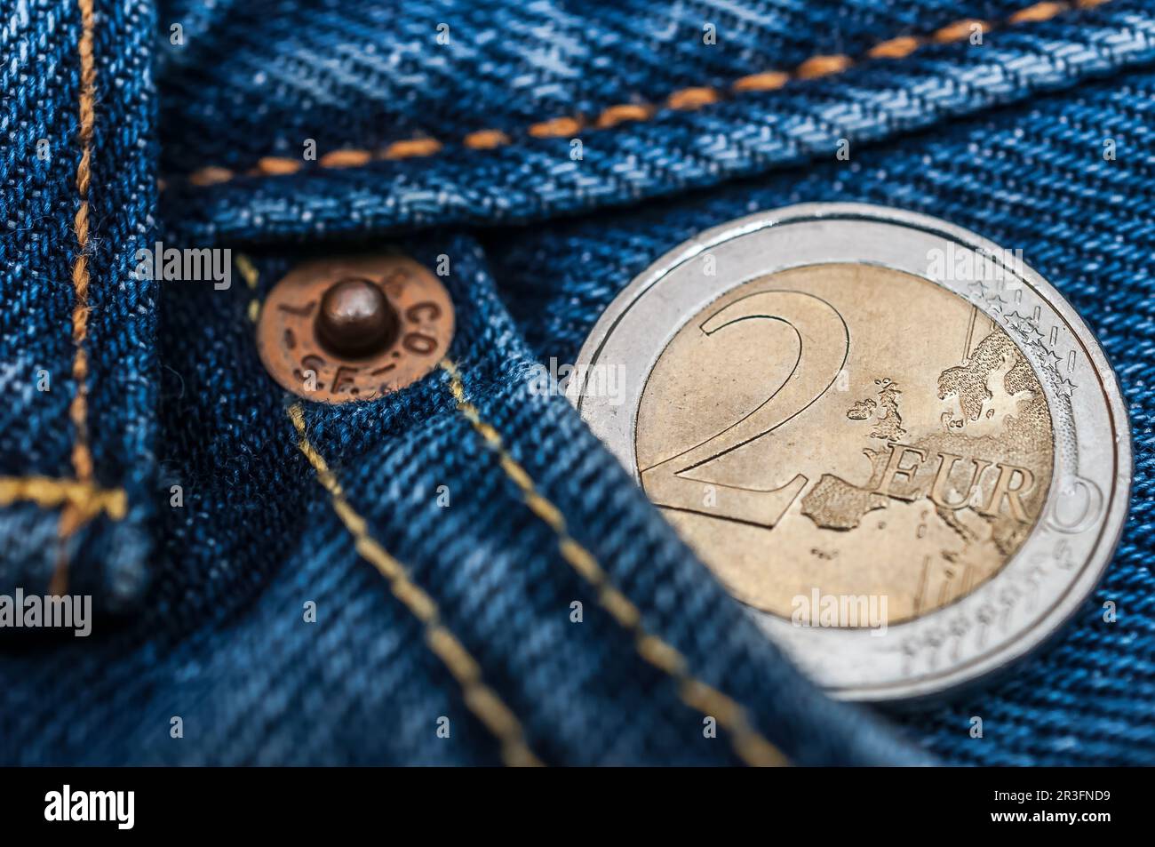 2-Euro-Münze in Jeanshose Stockfoto