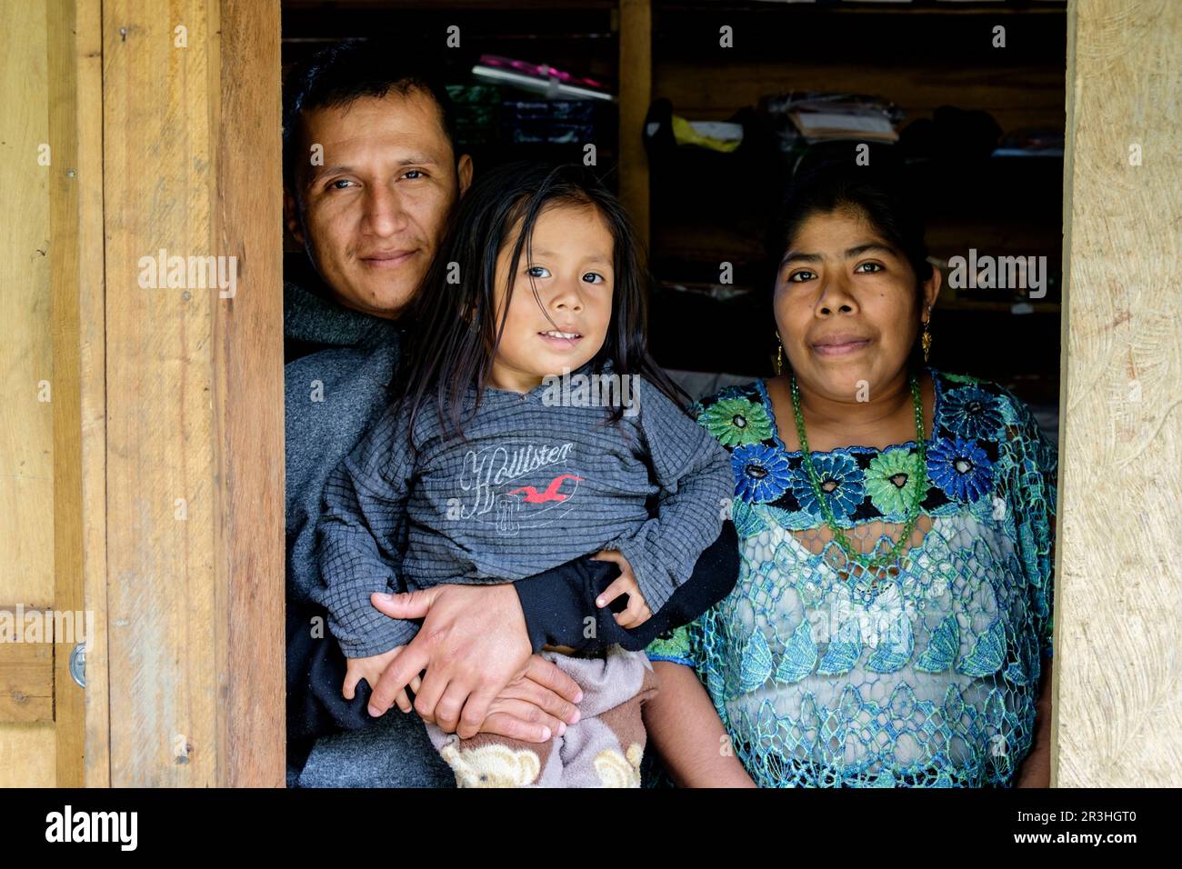 Familia en una Ventana, Lancetillo - La Parroquia, Franja Transversal del Norte, Departamento de Quiché, Guatemala. Stockfoto