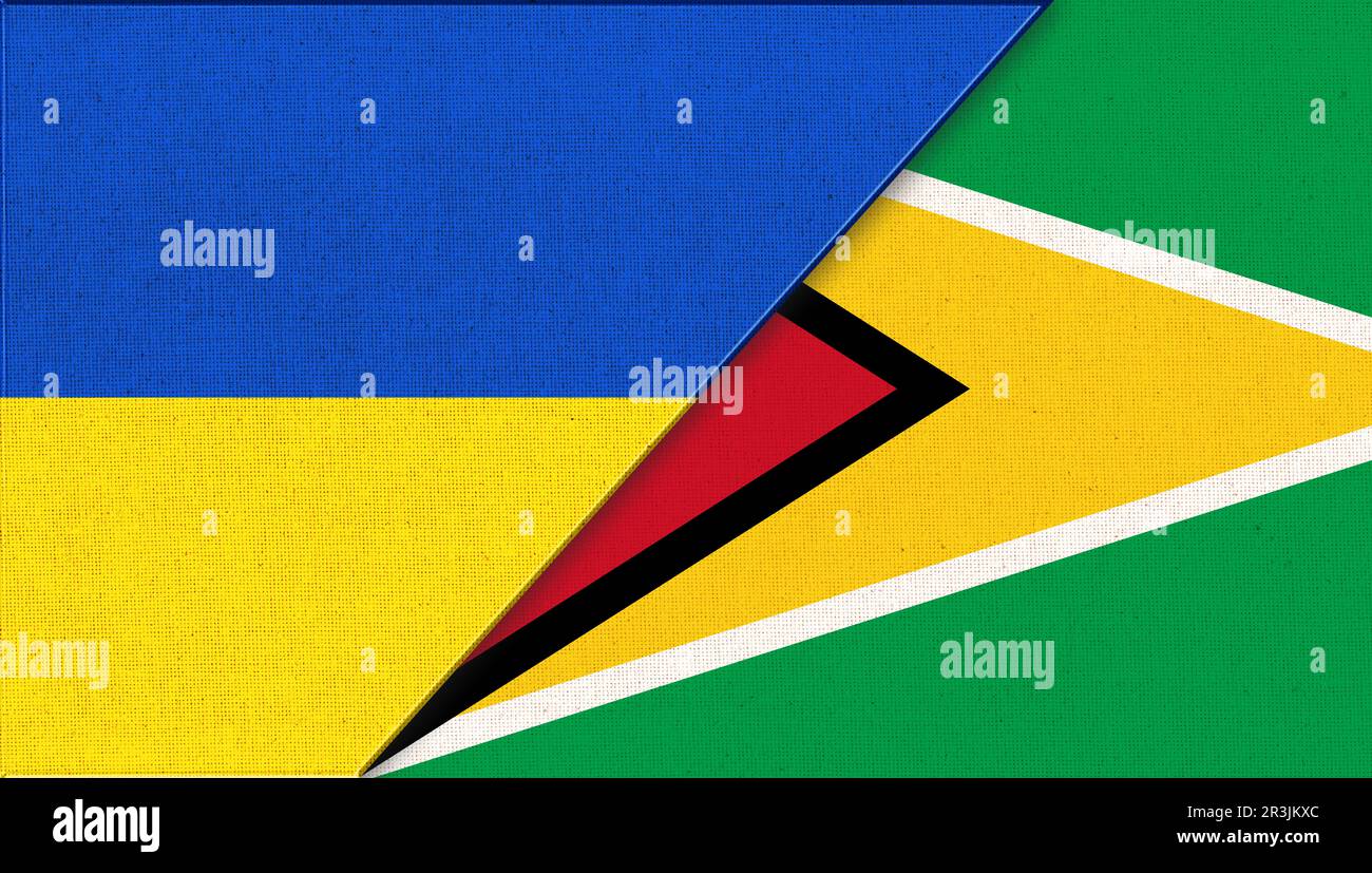 Flaggen der Ukraine und Guyanas. Ukrainische und guyanische Flaggen auf Stoffoberfläche. Nationale Symbole Stockfoto