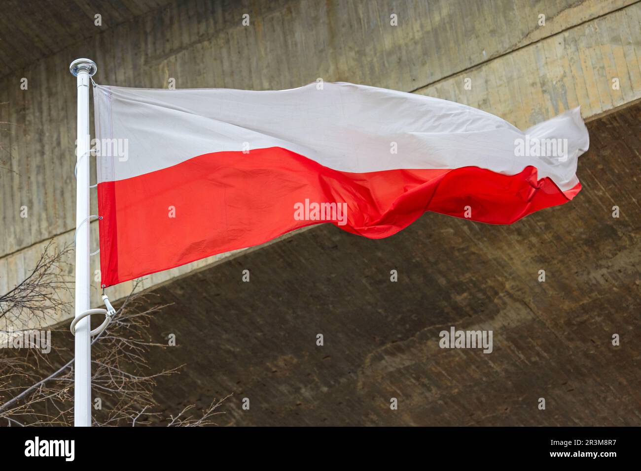 Polnische Nationalflagge vor Betonstruktur Stockfoto