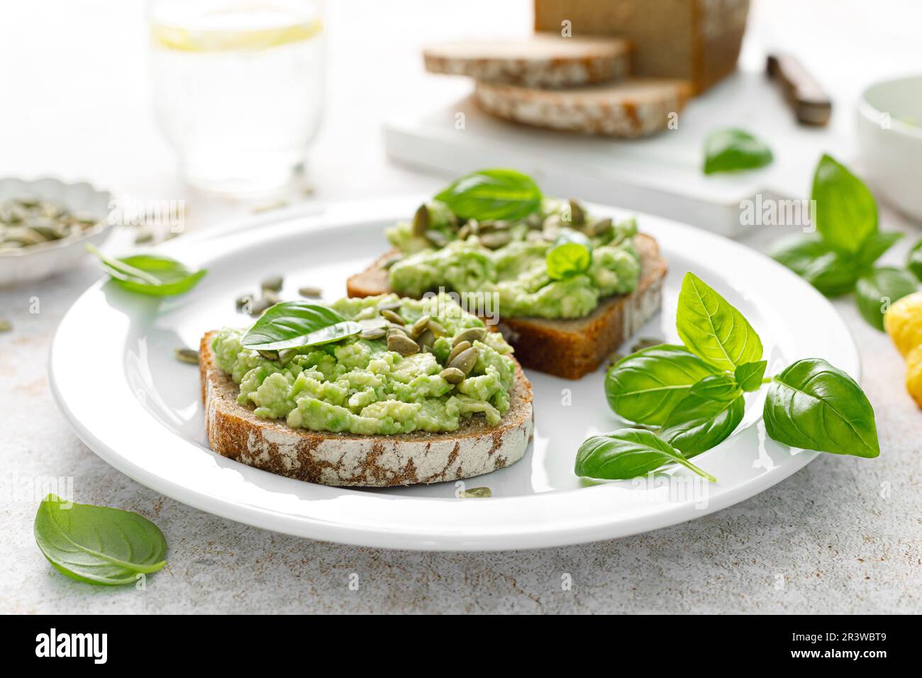 Avocado-Sandwich mit Kürbiskernen. Gesunder vegetarischer Avocado Toast mit Roggenbrot zum Frühstück. Vegane Speisekarte Stockfoto