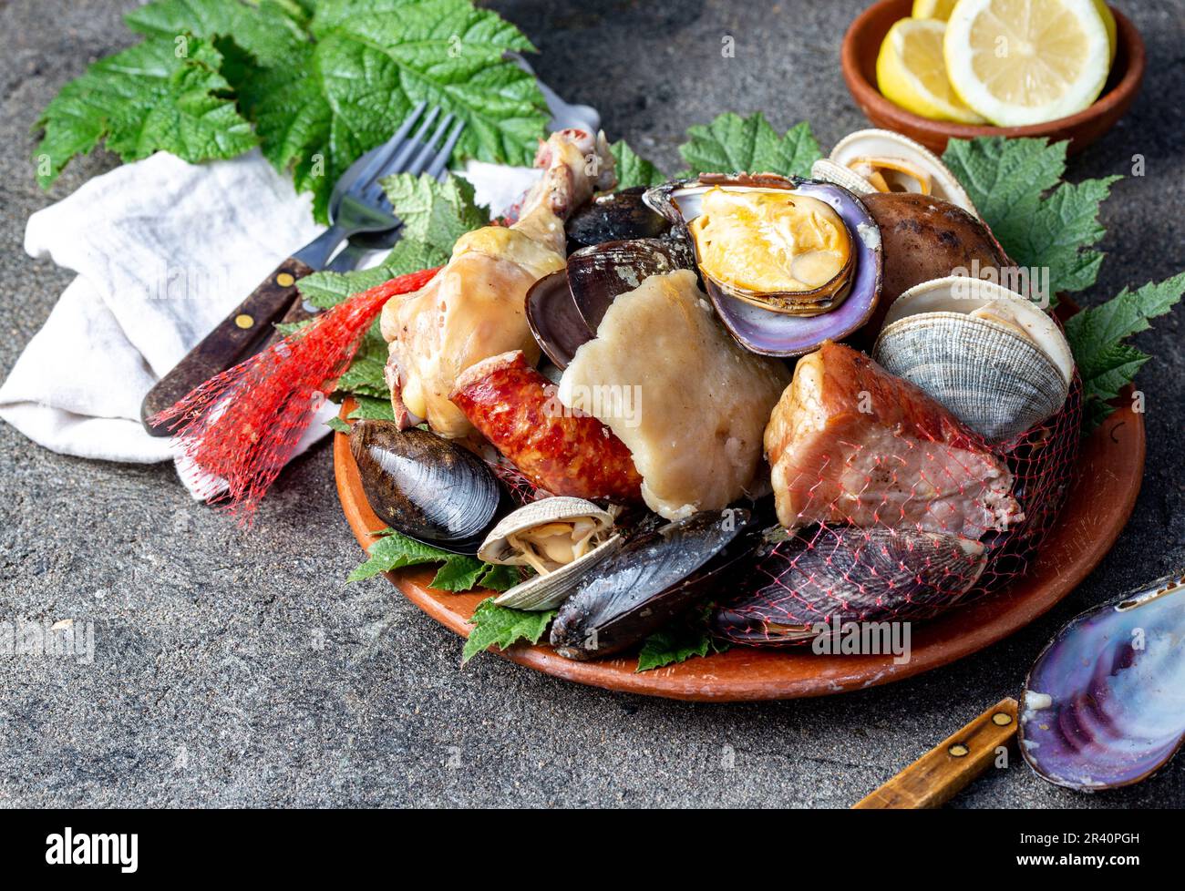 Berühmtes traditionelles Gericht im Süden Chiles und der Chiloe-Inselgruppe - Curanto al Hoyo, Kuranto. Verschiedene Meeresfrüchte, Fleisch A. Stockfoto