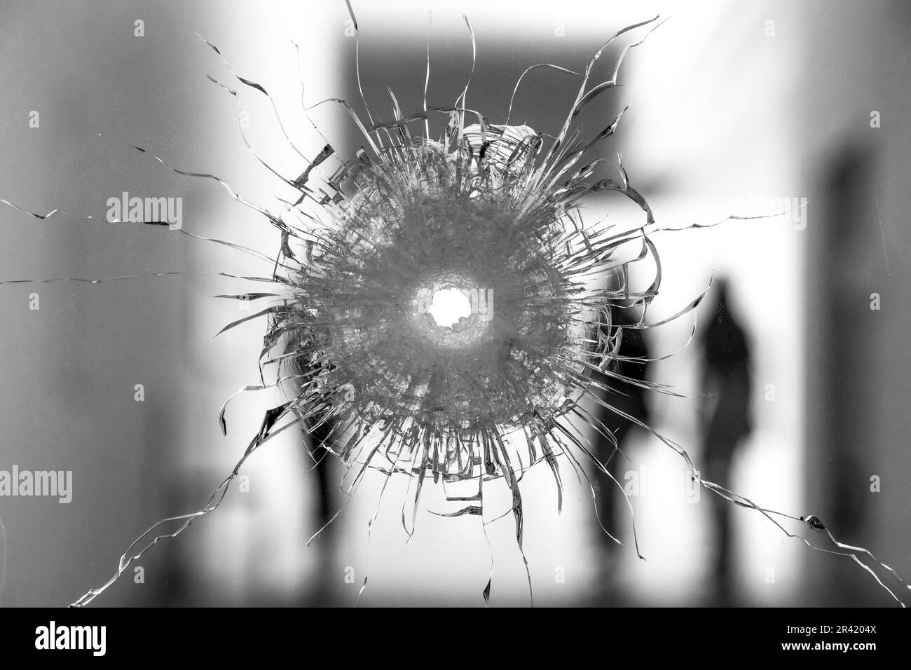 Rundloch im Glas mit Silhouetten im Hintergrund Stockfoto