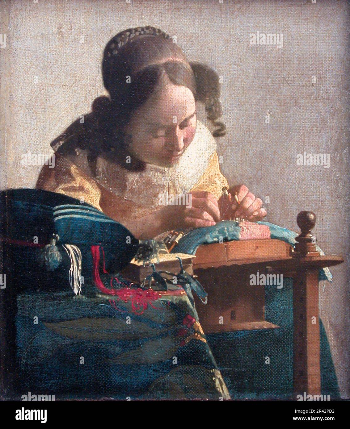 Der Lacemaker wurde 1670-1671 vom niederländischen Maler des Goldenen Zeitalters Johannes Vermeer gemalt Stockfoto