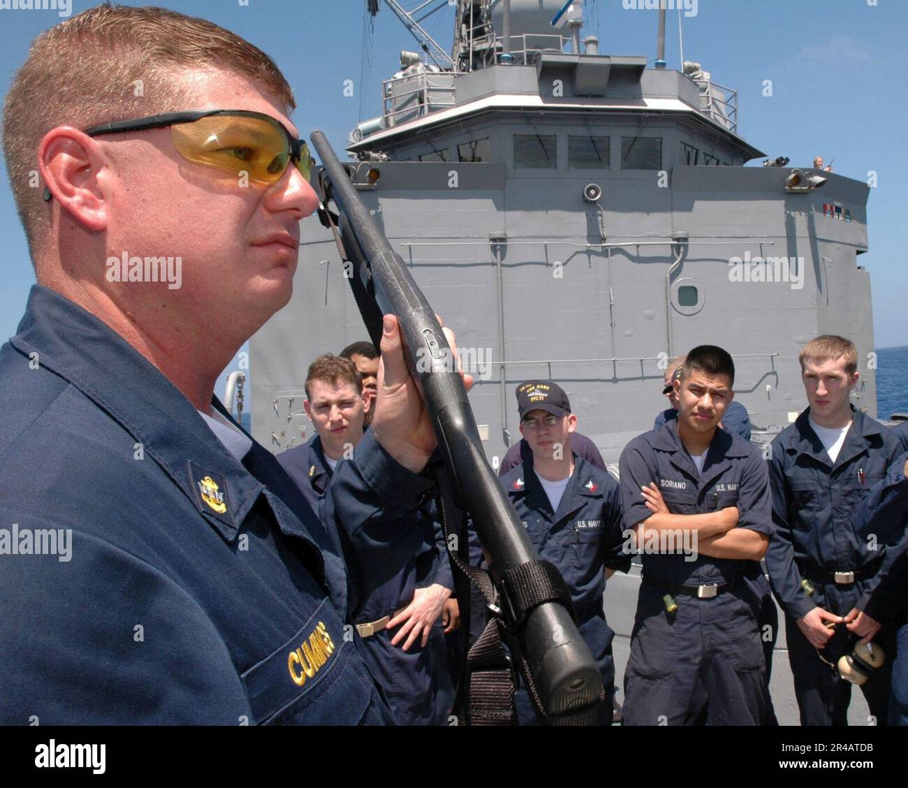 Der Mate des US Navy Chief Gunner demonstriert die unterschiedlichen Bedingungen der Bereitschaft für die Mossberg-Schrotflinte mit einer Stärke von 12, die an Bord der geführten Raketenfregatte USS Gary (FFG 51) verwendet wird. Stockfoto