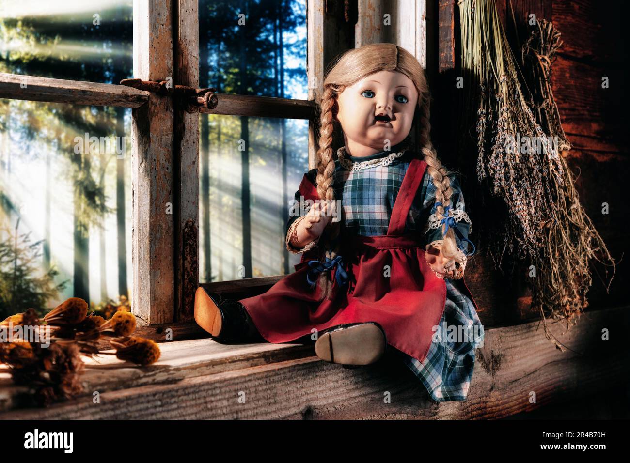 Antike Porzellanpuppe auf einer rustikalen Fensterbank mit Blick auf die Landschaft, komponiert, Deutschland Stockfoto