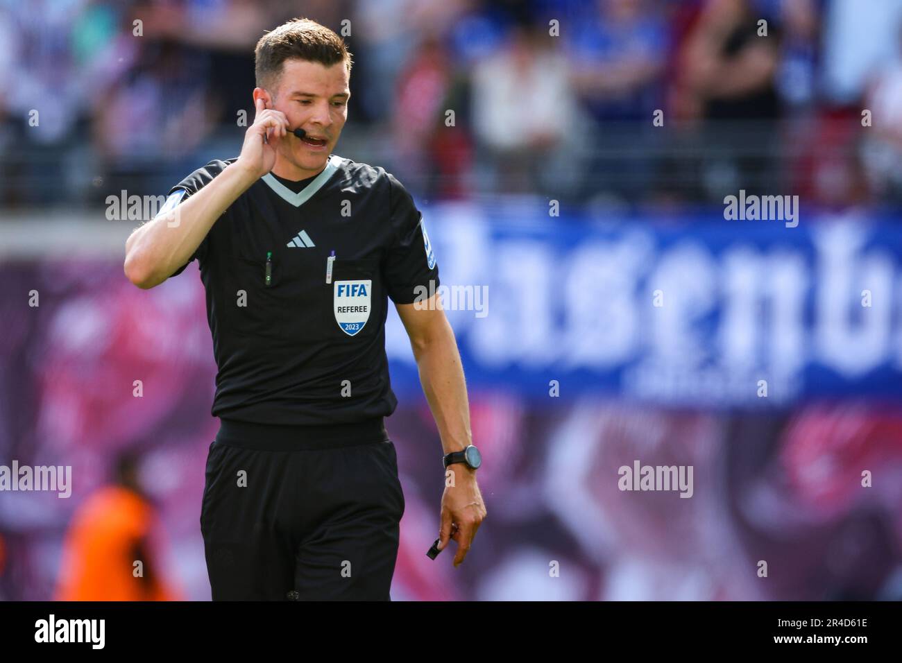 Leipzig, Deutschland. 27. Mai 2023. Fußball: Bundesliga, Matchday 34, RB Leipzig - FC Schalke 04 in der Red Bull Arena. Schiedsrichter Harm Osmers kommuniziert mit dem Schiedsrichter. Kredit: Jan Woitas/dpa - WICHTIGER HINWEIS: Gemäß den Anforderungen der DFL Deutsche Fußball Liga und des DFB Deutscher Fußball-Bund ist es verboten, im Stadion aufgenommene Fotos und/oder das Spiel in Form von Sequenzbildern und/oder videoähnlichen Fotoserien zu verwenden oder verwenden zu lassen./dpa/Alamy Live News Stockfoto