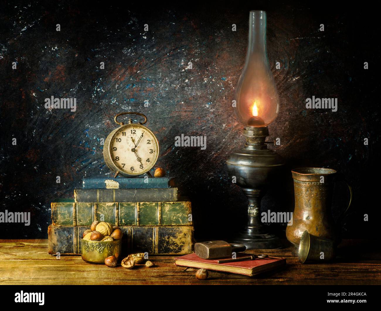 Klassisches Stillleben mit altmodischer, beleuchteter Lampe mit alten Büchern, Uhr, Nüssen, Kupferglas, altem Schlüssel, Und auf rustikalem Holzhintergrund verriegeln. Stockfoto