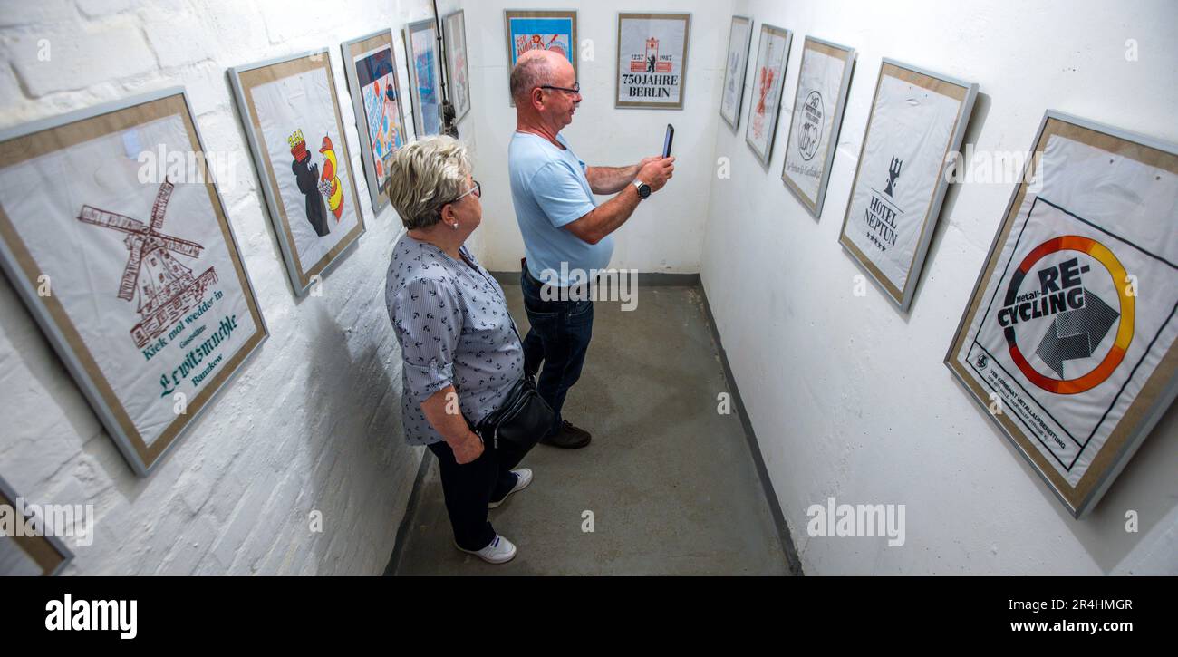 28. Mai 2023, Mecklenburg-Vorpommern, Zürow: Besucher besichtigen einen ehemaligen DDR-Bunker und sehen die Ausstellung mit einer Sammlung von DDR-Einkaufstaschen. Collector Luchs, 83, stellt insgesamt 120 Plastiktüten in der unterirdischen Betonstruktur in einem Wald bei Wismar aus. Seit Jahrzehnten sammelt der ausgebildete Schreibmaschinenleser die Taschen mit Motiven von FDJ-Treffen, der DDR Volkspolizei oder Werbegrafiken für ostdeutsche Unternehmen und wird einen Teil seiner Sammlung interessierten Besuchern im 140 Quadratmeter großen Bunker am Pfingstsonntag präsentieren. Das Bunkergebäude von t Stockfoto