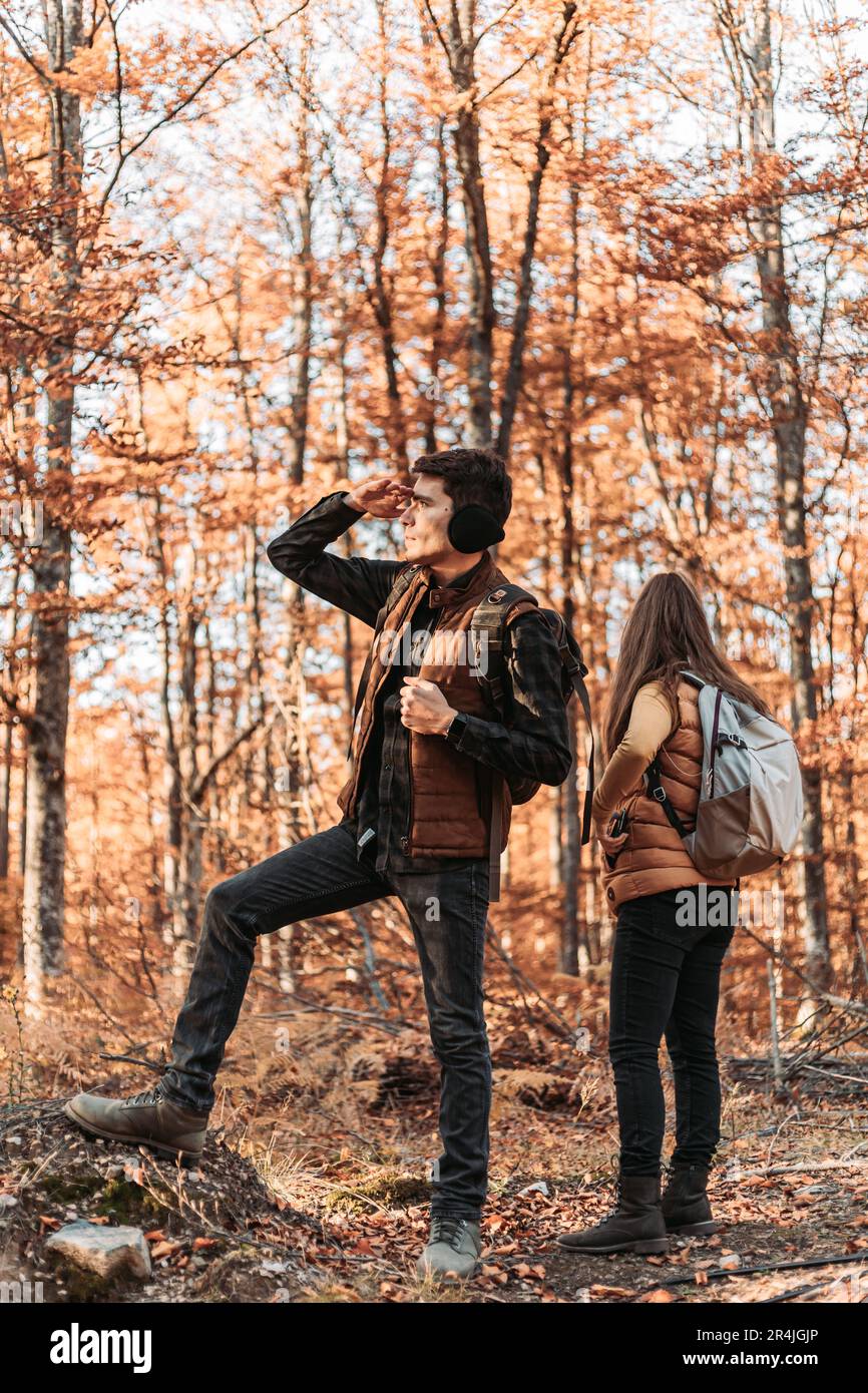 Junges Paar, das sich etwas im Wald ansieht. Wandern, im Freien Stockfoto