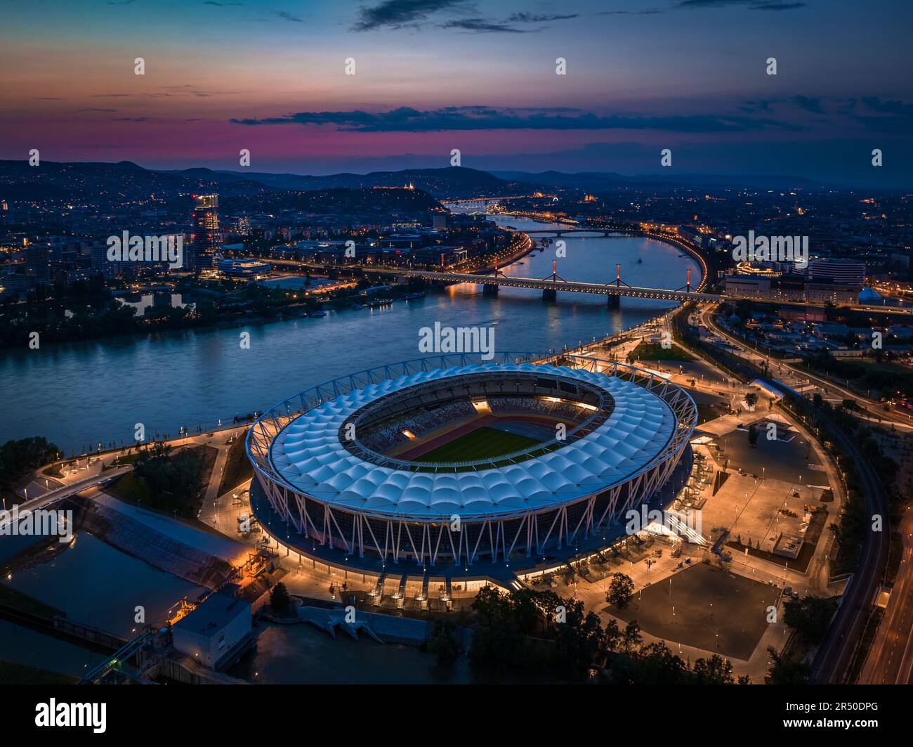 Budapest, Ungarn - Skyline von Budapest in der Dämmerung, einschließlich beleuchtetem National Athletics Centre, Rakoczi-Brücke, MOL Campus Wolkenkratzer Stockfoto