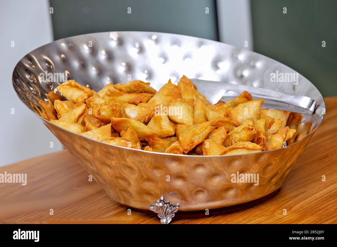 Samosa ist ein frittiertes Gebäck mit einer gewürzten Füllung, das in der Regel aus Kartoffeln, Gewürzen und Kräutern hergestellt wird. Manchmal werden diese auch mit Hackfleisch/Faschiertem zubereitet Stockfoto