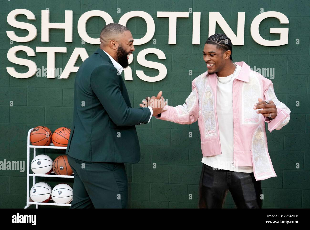 Professional basketball players Sterling "Scoot" Henderson, right, who portrays Romeo Travis