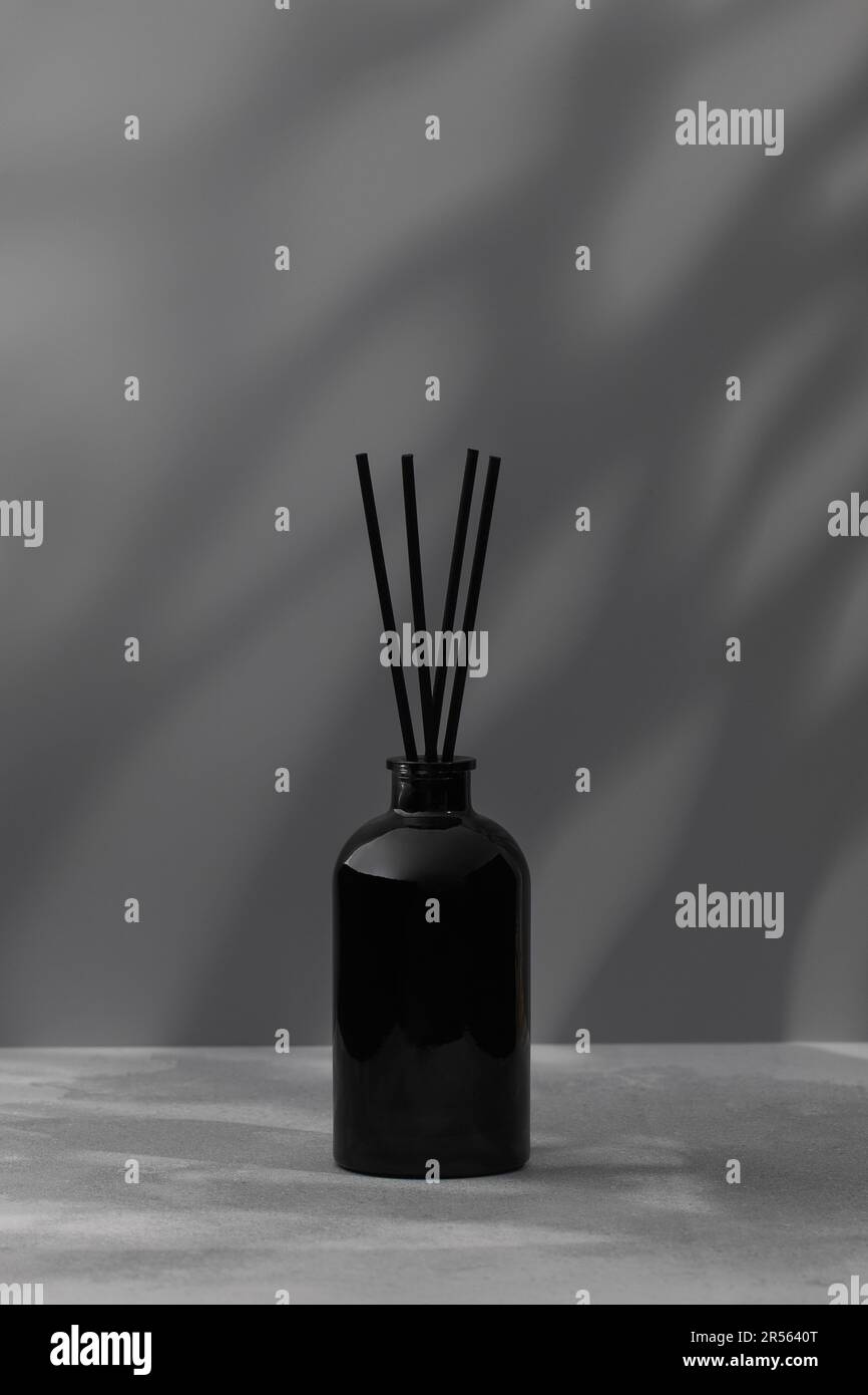 Bambus klebt in einer schwarzen Flasche mit Duftstoffen. Glasdiffusor mit  Duft für Zuhause Stockfotografie - Alamy