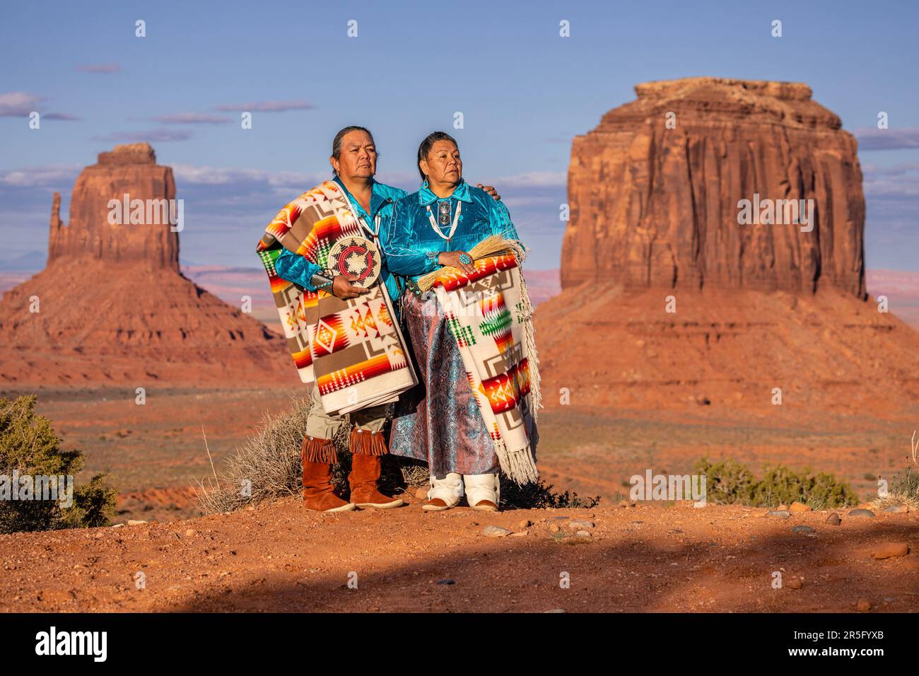 Ein amerikanisches Indianer-Navajo-Paar, das sich während des Sonnenuntergangs im Monument Valley Navajo Tribal Park, Arizona, USA, posiert Stockfoto