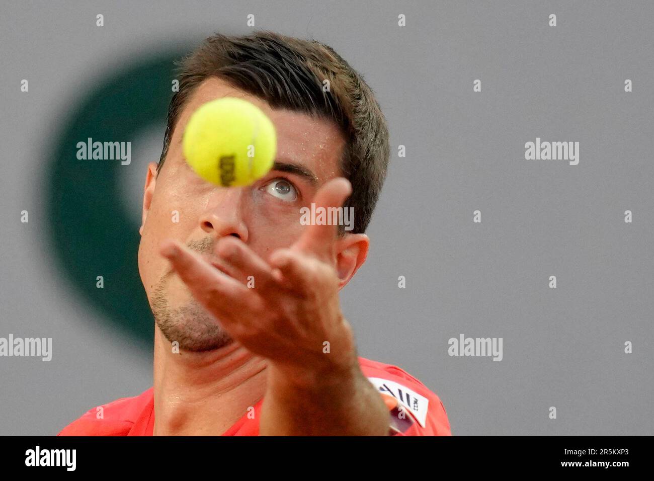 Austria's Sebastian Ofner serves against Greece's Stefanos Tsitsipas