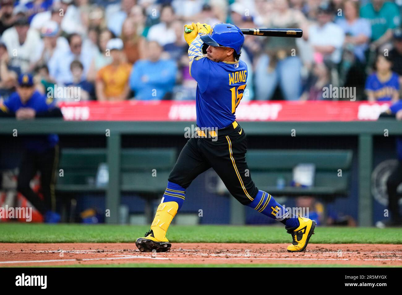 Seattle Mariners' Kolten Wong follows through against the Pittsburgh Pirates in a baseball game