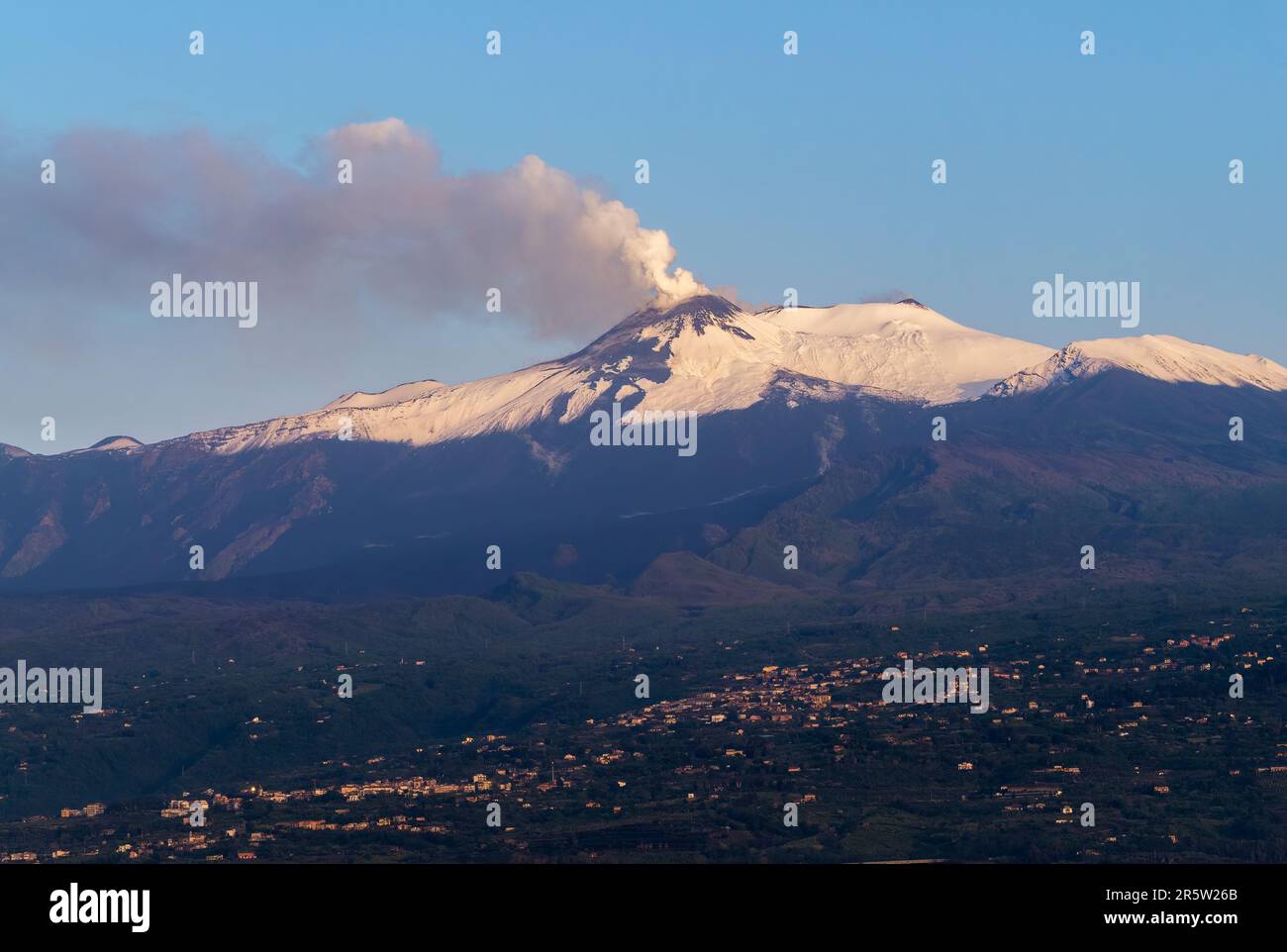 Der schneebedeckte Ätna, Sizilien bei Sonnenaufgang, mit Rauch, der am Tag nach einem Ausbruch aufgeht Stockfoto