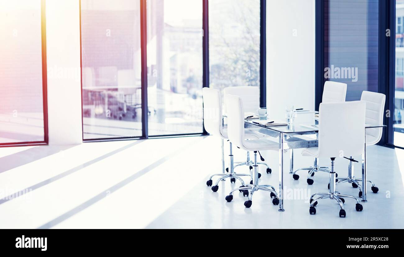 Verleihen Sie Ihrem Unternehmen neue Energie und Leben. Ein leerer Sitzungssaal mit Tisch und Stühlen. Stockfoto