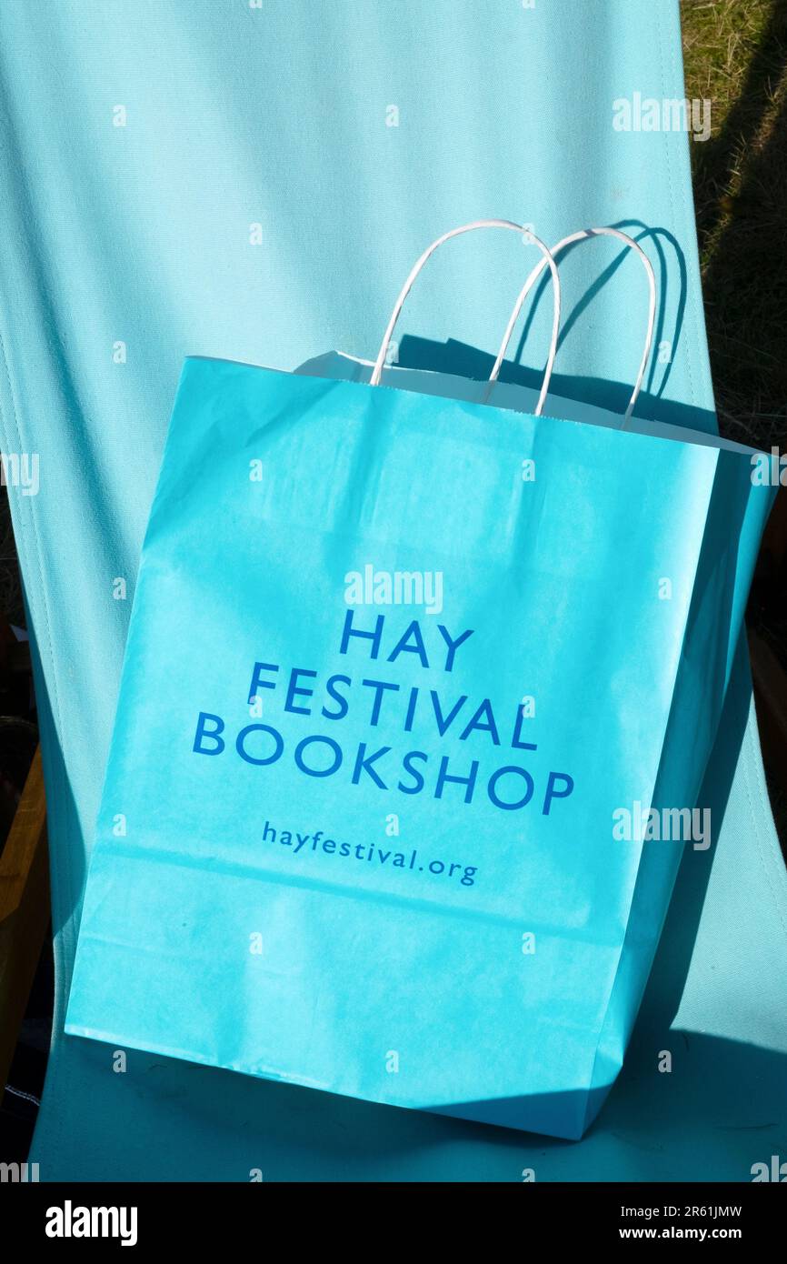 Türkisfarbene Tragetasche für den Hay Festival Bookshop auf blauem Segeltuch für den Liegestuhl beim Hay Festival 2023 in Hay-on-Wye Wales UK Stockfoto