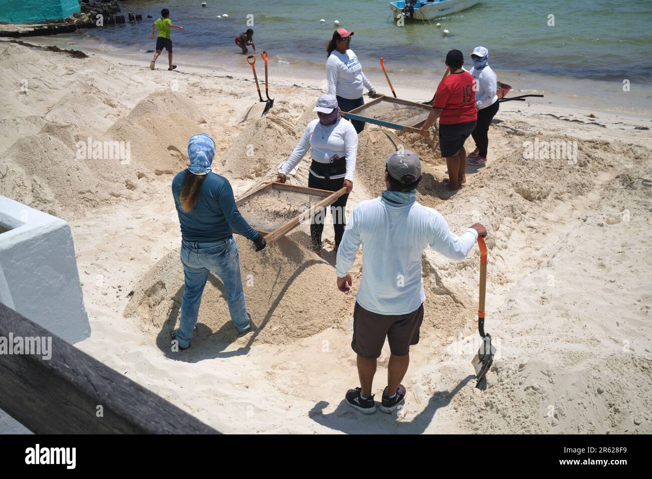 Blue Flag Arbeiter reinigen den Strand Sand in Puerto Morelos Yucatan Mexiko Stockfoto