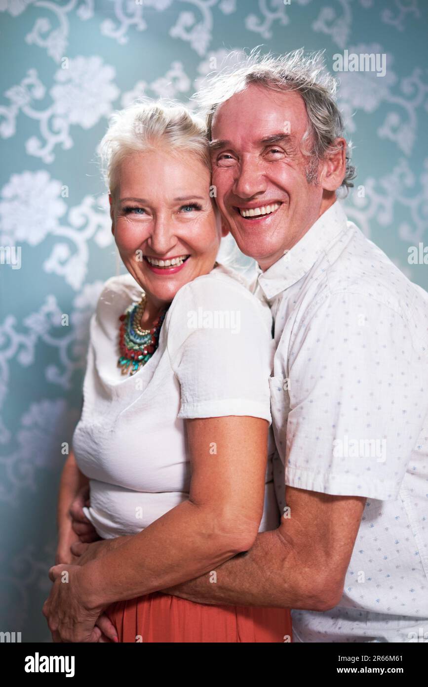 Portrait glücklich, sorgenfreies Seniorenpaar umarmt Stockfoto