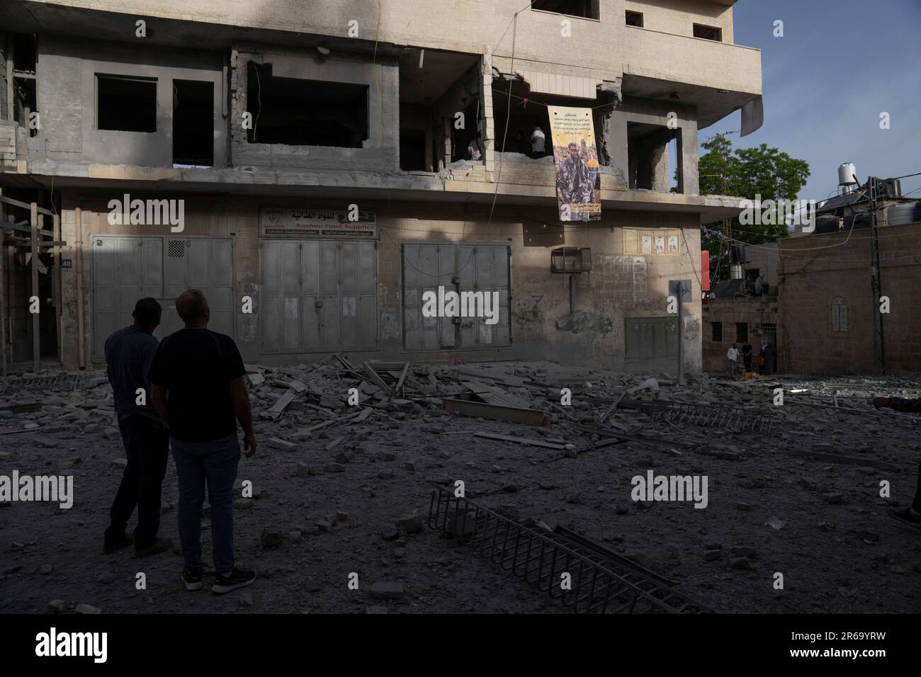 Palestinians inspect the demolished apartment of Palestinian Islam