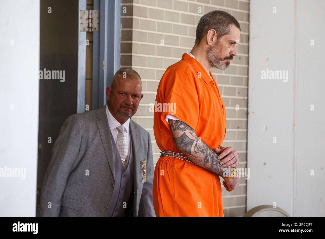 Escaped inmate Casey White, right, is escorted from the Lauderdale