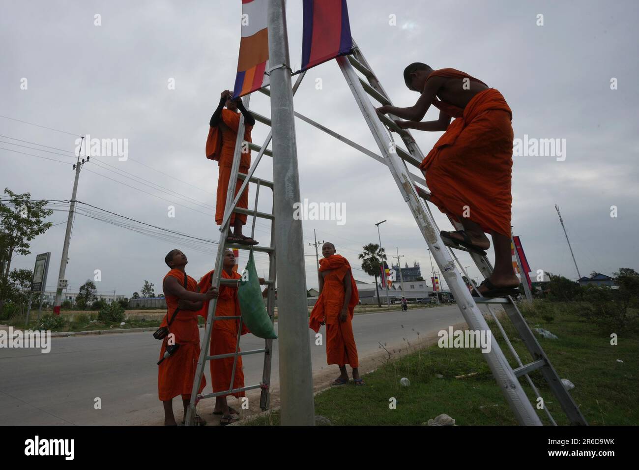 Cambodian Buddhist monks decorate Buddhist and their national flags as