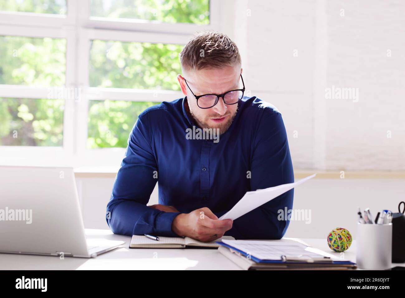 Trauriger Mann Liest Papierrechnung Mit Stress Stockfoto