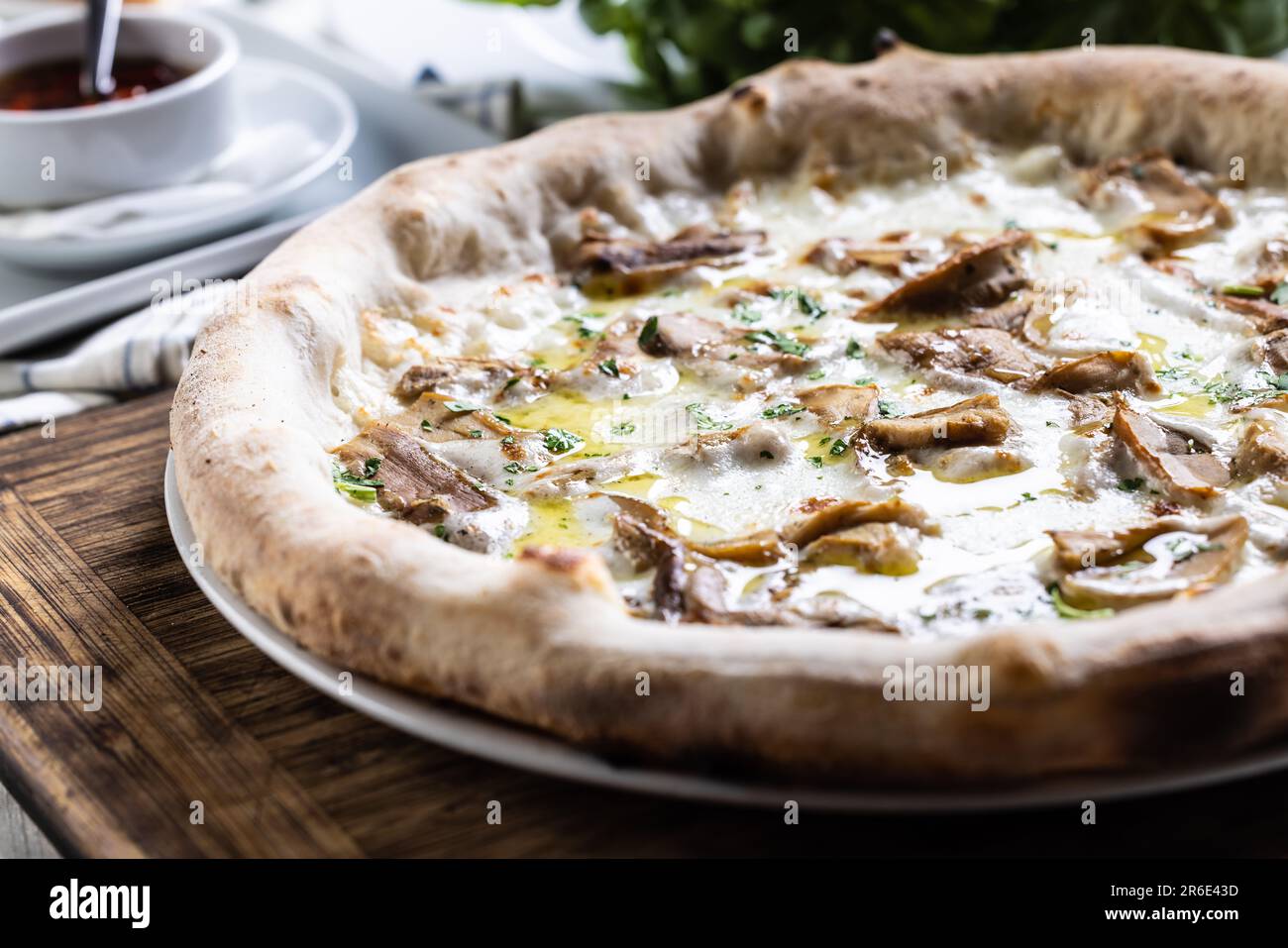 Pilzpizza mit Käse und knusprigen Kanten, frisch aus dem Ofen genommen. Stockfoto