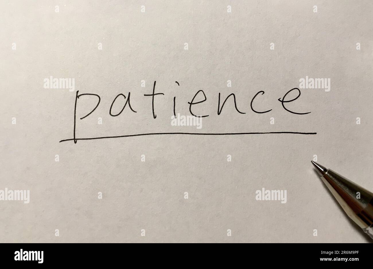 Geduld-Konzeptwort auf Papierhintergrund Stockfoto