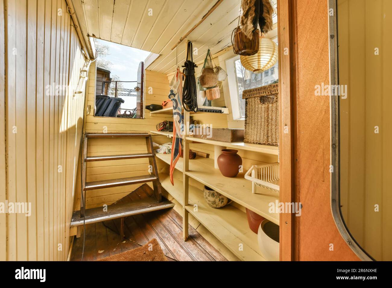 Das Innere eines Lkws mit Holzverkleidung an den Wänden und Holzregalen im Innenraum ist gelb lackiert Stockfoto