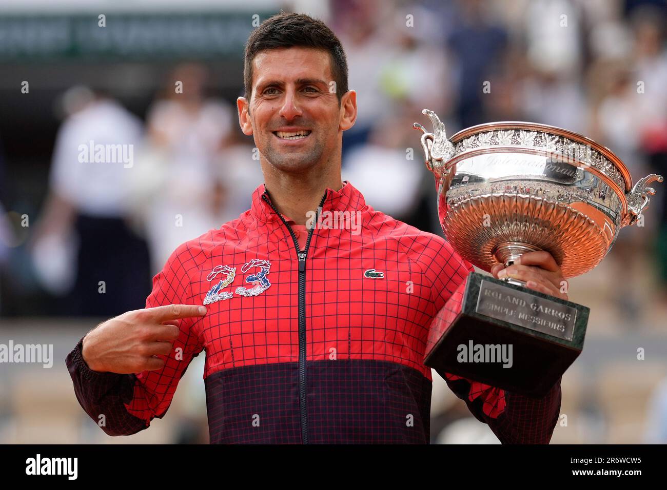 Serbia's Novak Djokovic points at 23 on his garment as he celebrates