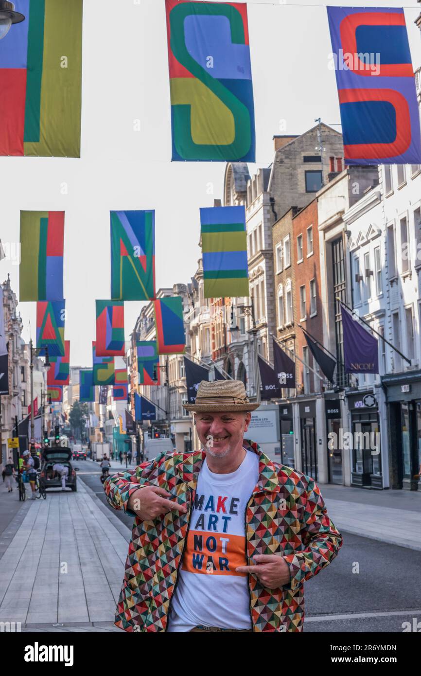 London, Großbritannien. 12. Juni 2023. Der gefeierte Royal Academician Bob & Roberta Smith steht unter seinen kühnen und lebendigen Flaggen, die über der Bond Street fliegen, um den Beginn der Kunst in Mayfair zu feiern, einer 4-wöchigen Feier der lebendigen Kunst- und Kulturszene der Gegend. Paul Quezada-Neiman/Alamy Live News Credit: Paul Quezada-Neiman/Alamy Live News Credit: Paul Quezada-Neiman/Alamy Live News Stockfoto