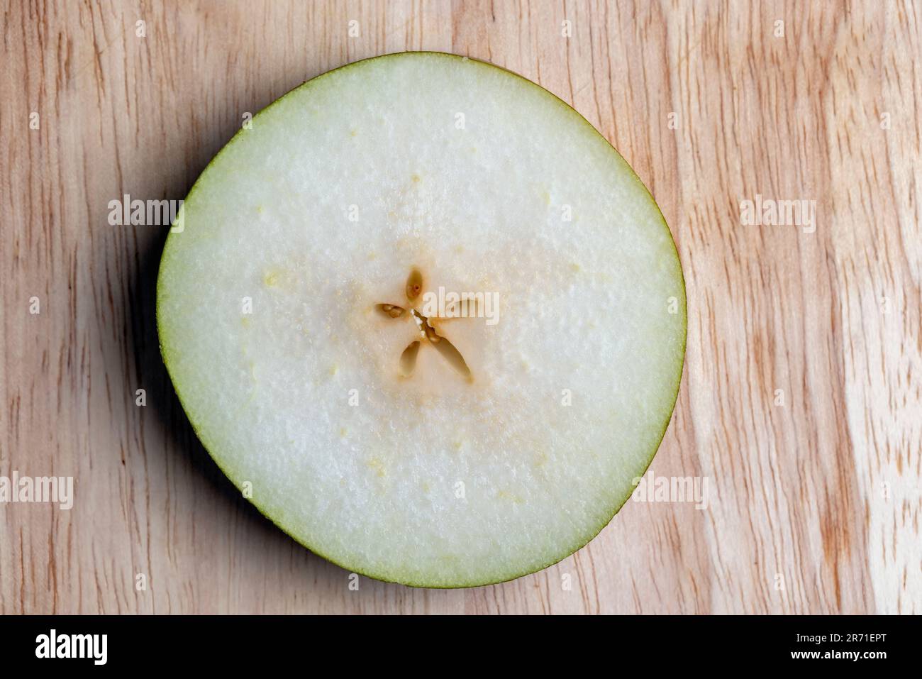 Zerstückelte Birne auf dem Tisch, reife Birne in Scheiben geschnitten Stockfoto