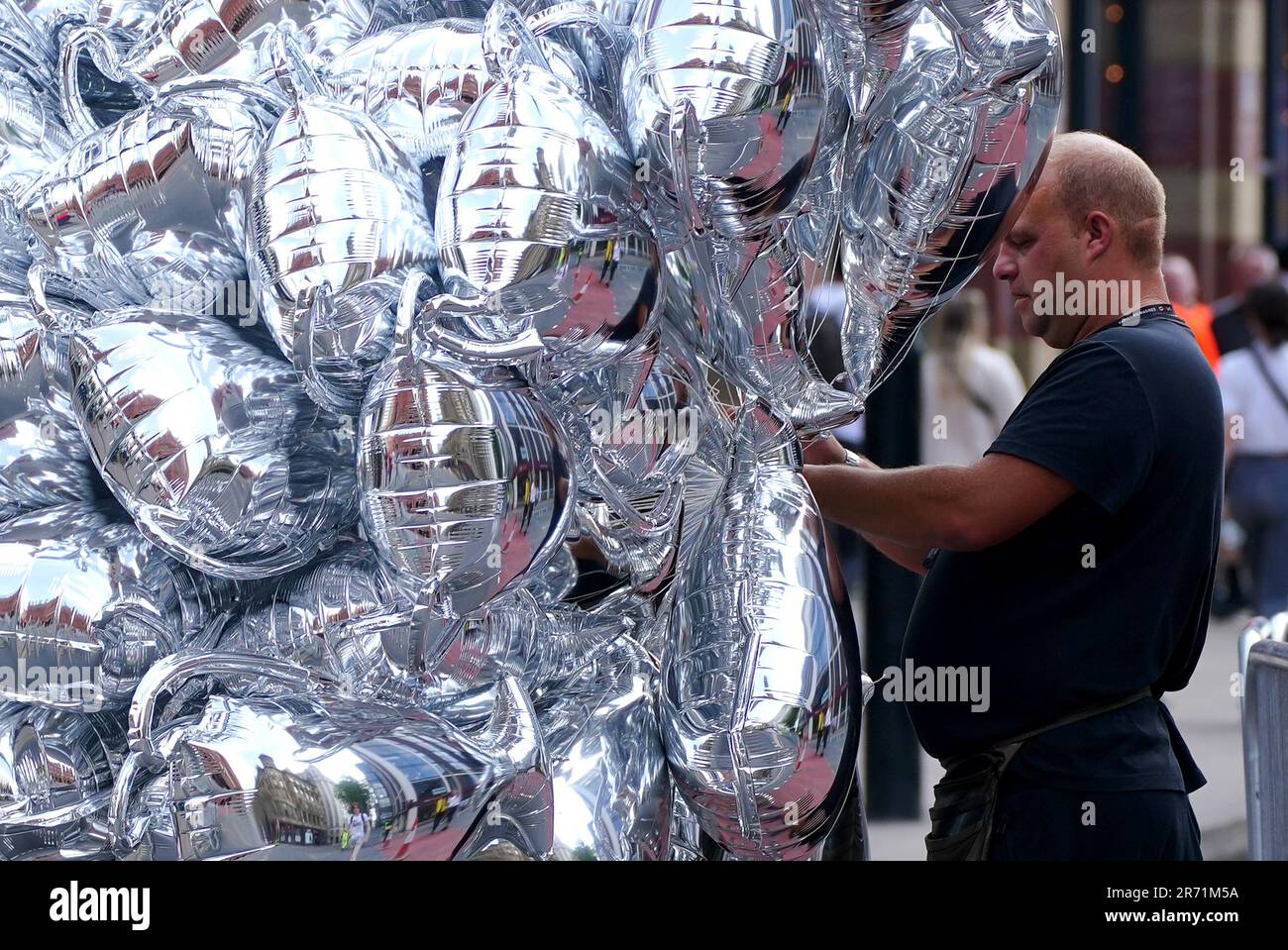 Ballons in Trophäenform zum Verkauf vor der Treble Parade in Manchester. Manchester City schloss die Treble (Champions League, Premier League und FA Cup) nach einem Sieg von 1-0 über Inter Mailand in Istanbul und sicherte ihnen den Ruhm der Champions League. Foto: Montag, 12. Juni 2023. Stockfoto