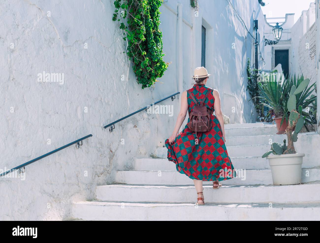 Ein junges Mädchen spaziert durch die Straßen der historischen weißen Stadt Ostuni in der italienischen Region Apulien Stockfoto