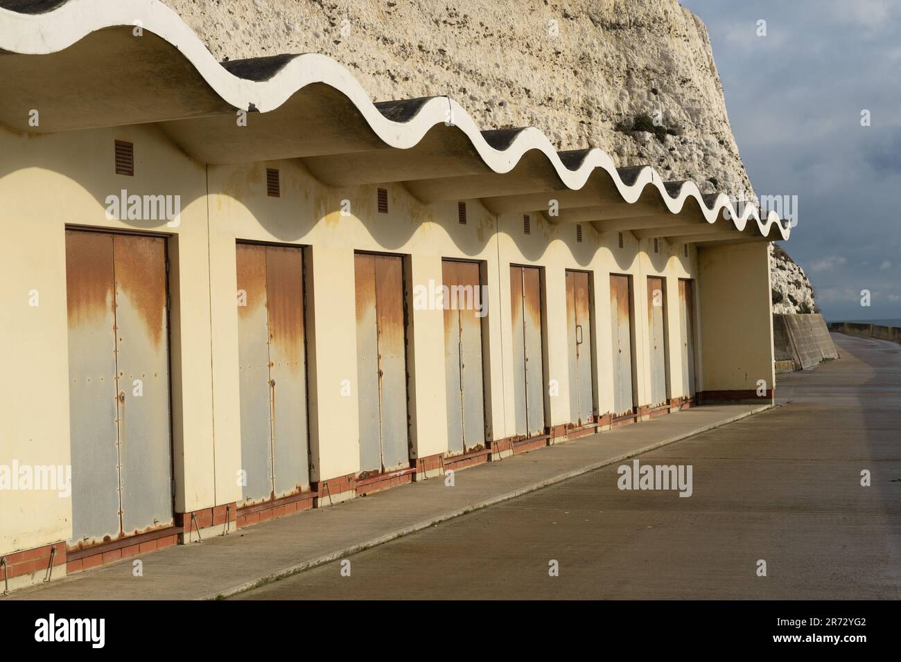 Künstlerische Strandhütten mit gewellter Dachlinie Stockfoto