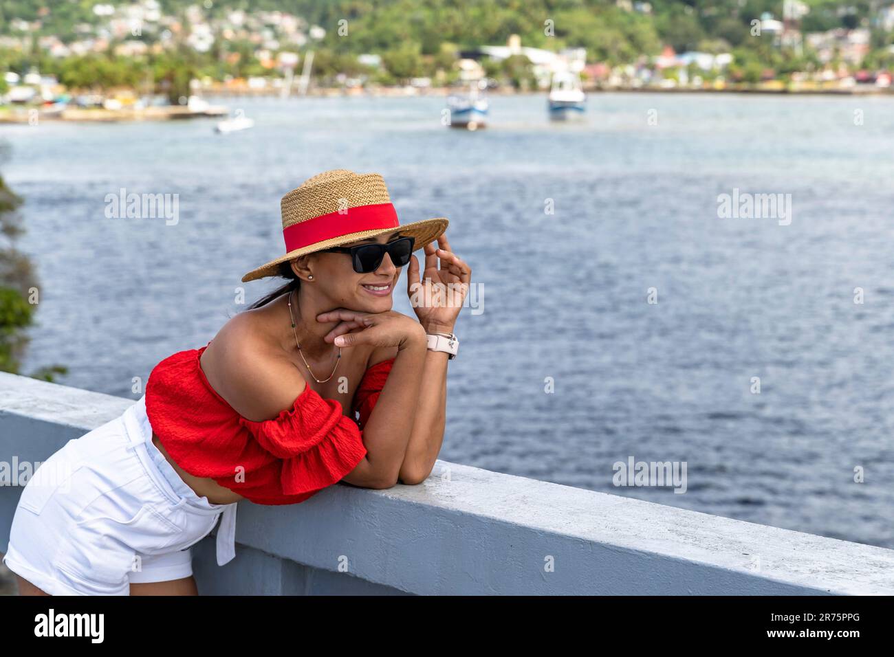 Nordamerika, Karibik, Großantillen, Hispaniola, Dominikanische Republik, Provinz Sama, Halbinsel Sama, Santa rbara de Sama, hübsche Latina, die sich auf dem Geländer der Brücke in Sama Bay lehnt Stockfoto