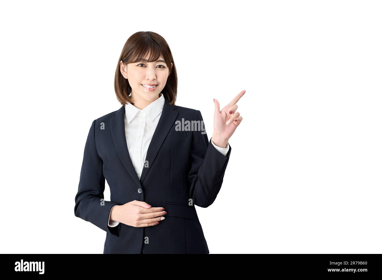 Asiatische Geschäftsfrau, die auf weißen Hintergrund zeigt Stockfoto