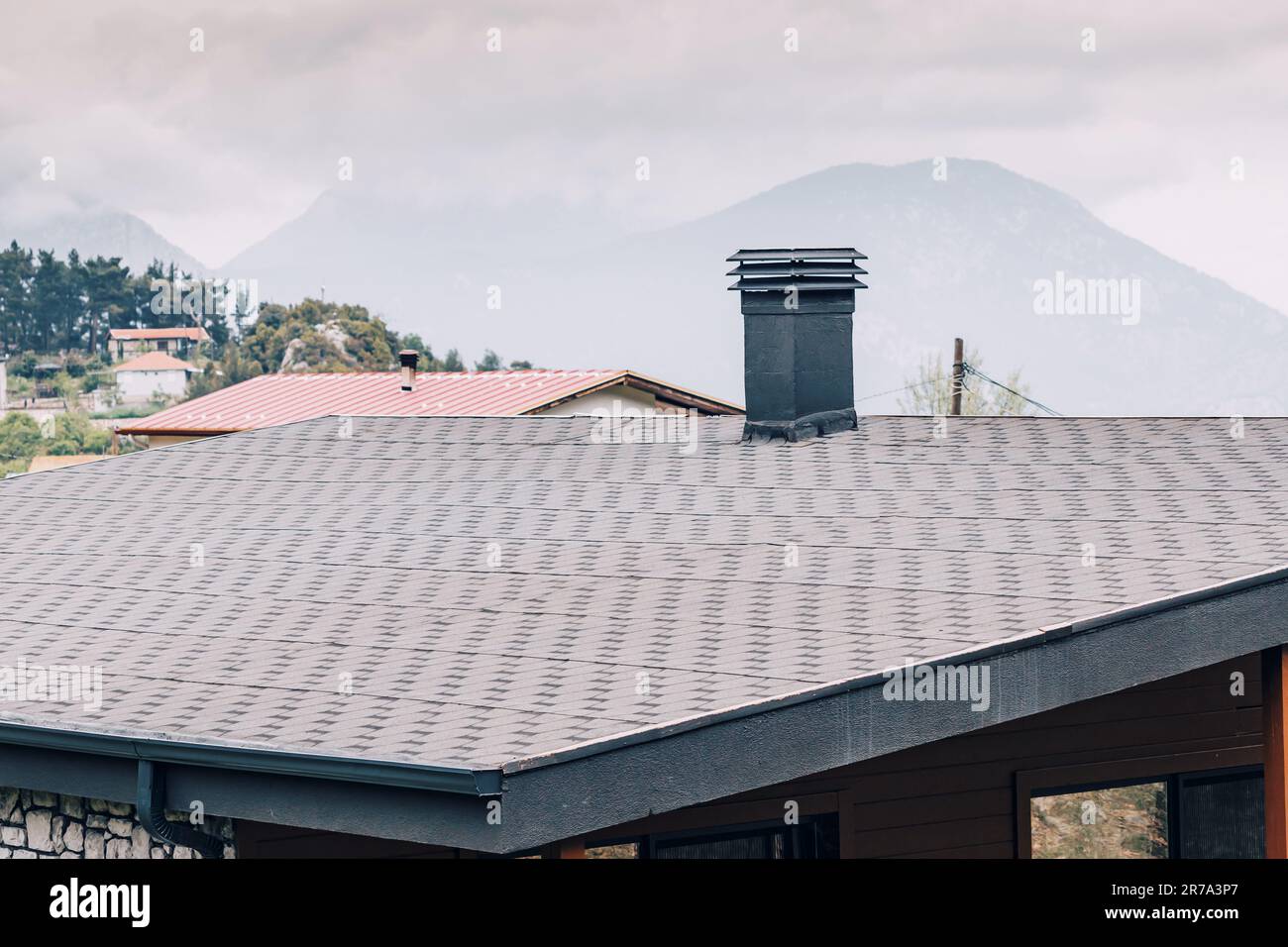 Dach mit Pfeife eines modernen Hauses im Dorf Stockfoto