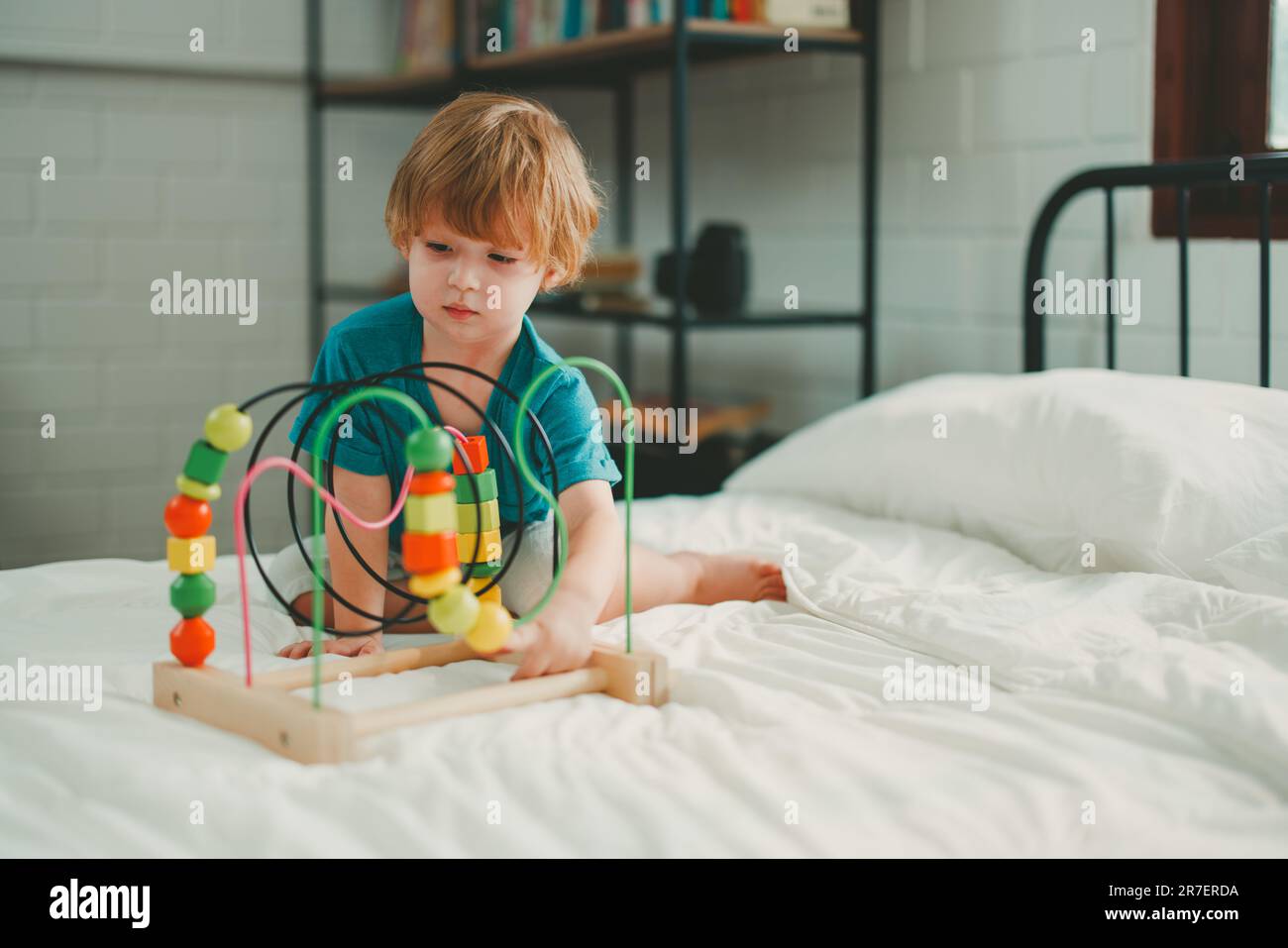 Neben lustigen Lernspielzeugen und Bausteinen fördern sie die Gehirnentwicklung, verbessern die Koordination der Hand und der Augen, fördern die Feinmotorik und fördern die Konzentration Stockfoto