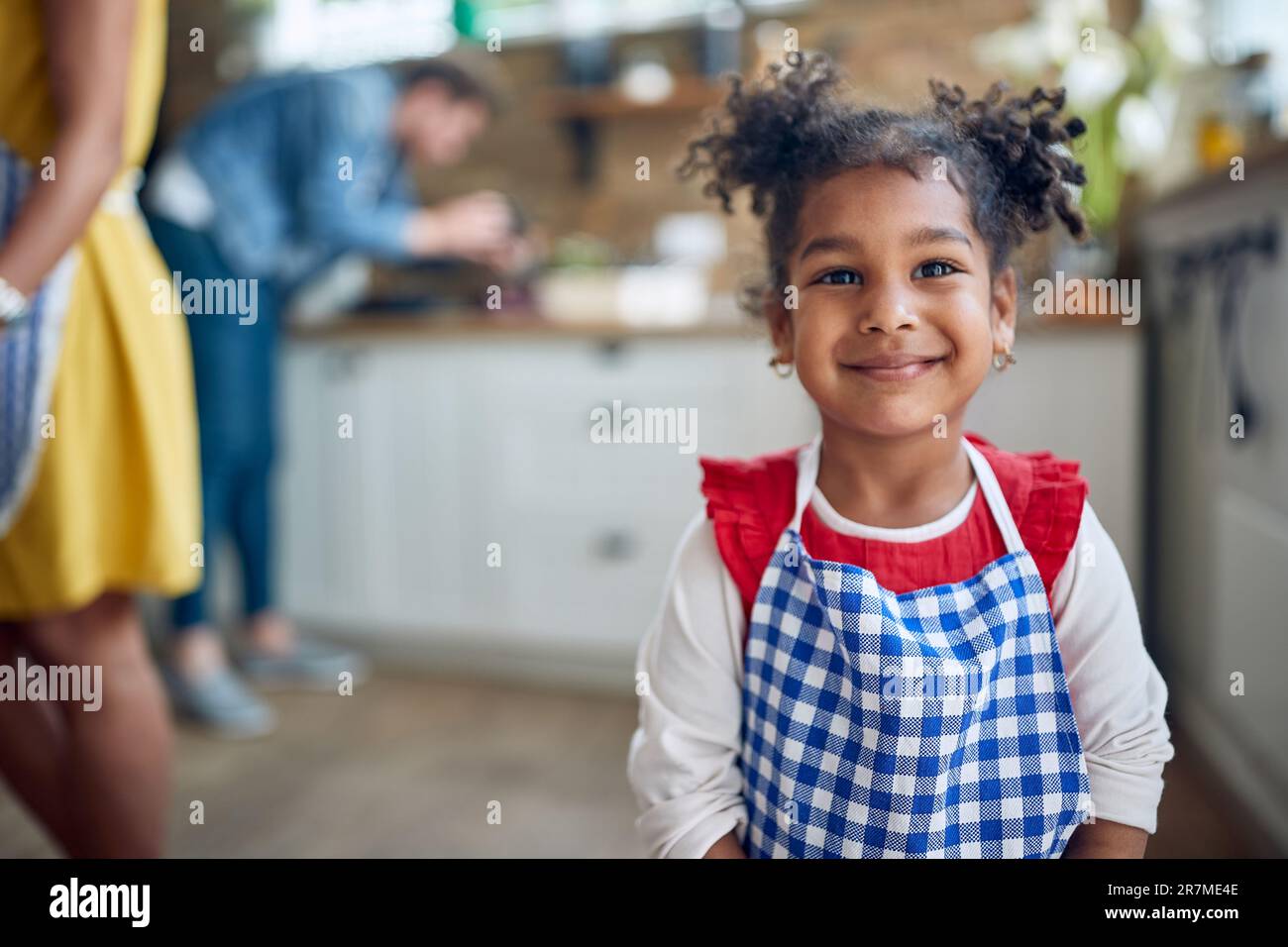 Das afroamerikanische Mädchen steht im Mittelpunkt, wenn es selbstbewusst in die Kamera blickt und ihr lebendiges Lächeln den Rahmen beleuchtet. Stockfoto